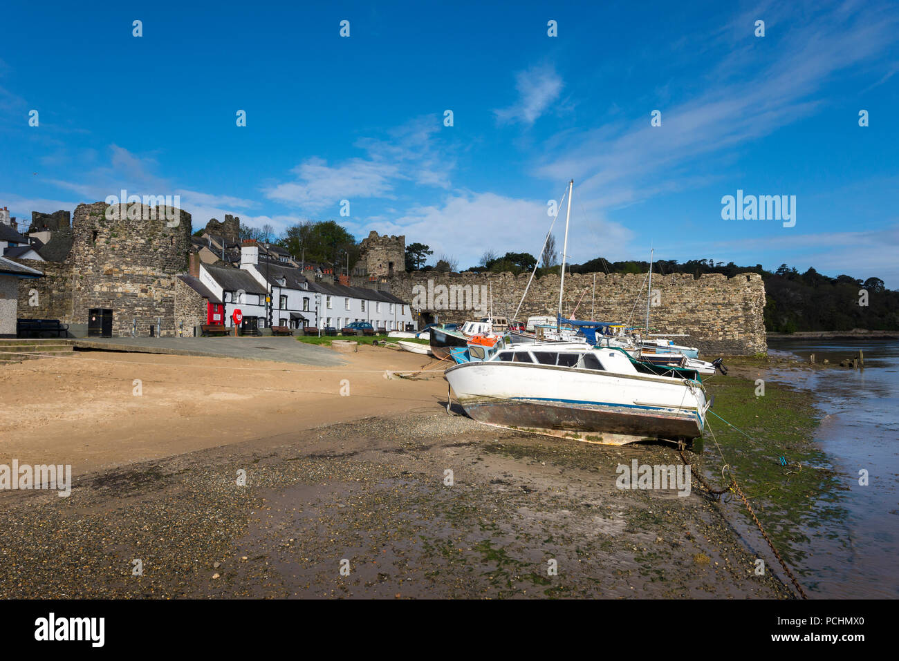 Small boats at Conwy harbour, North Wales. Beside the water just outside the old town walls and smallest house in Britain. Stock Photo