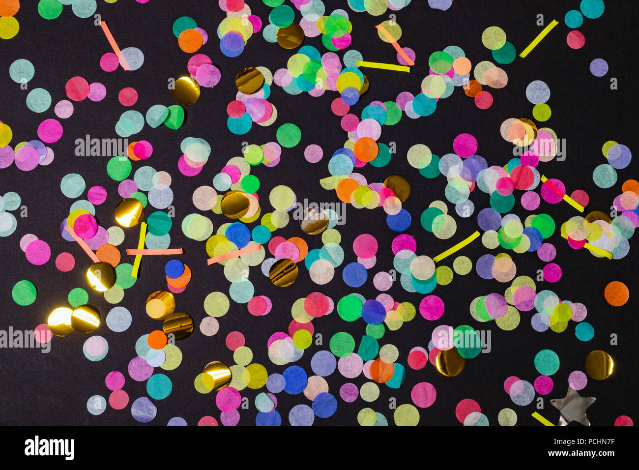 Colorful confetti on black background. Colorful party background. Top