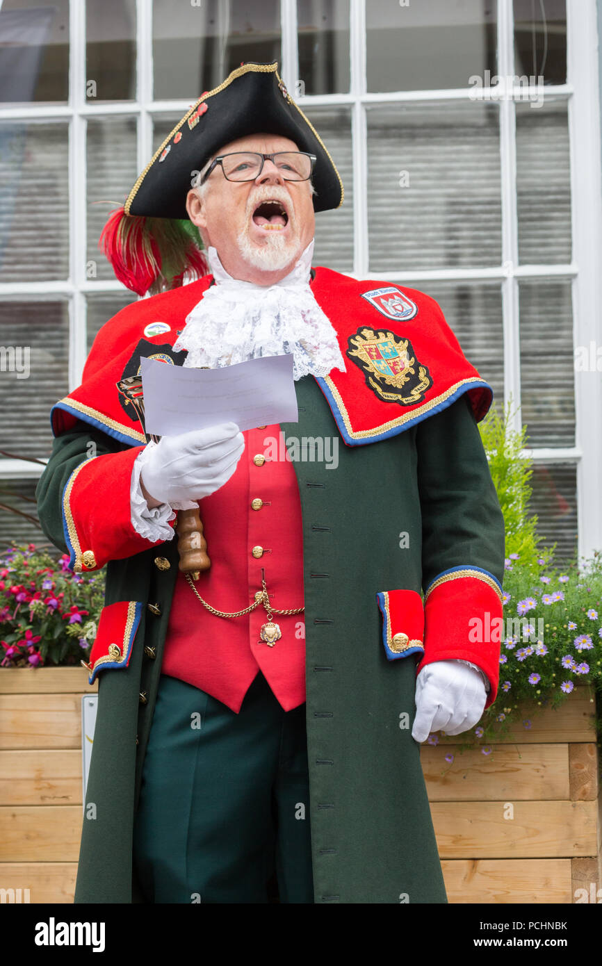 The Kendal Town Crier announcing news on Market day in the Cumbrian Market Town. Stock Photo