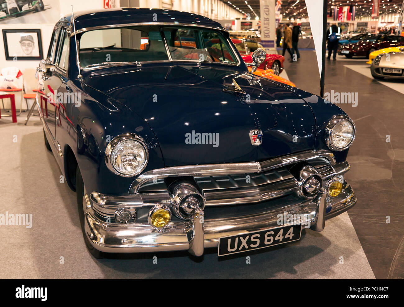 A Three-quarter front view of a  Blue, 1951 Ford Custom Deluxe Tudor V8, on display at the 2018 London Classic Car Show Stock Photo