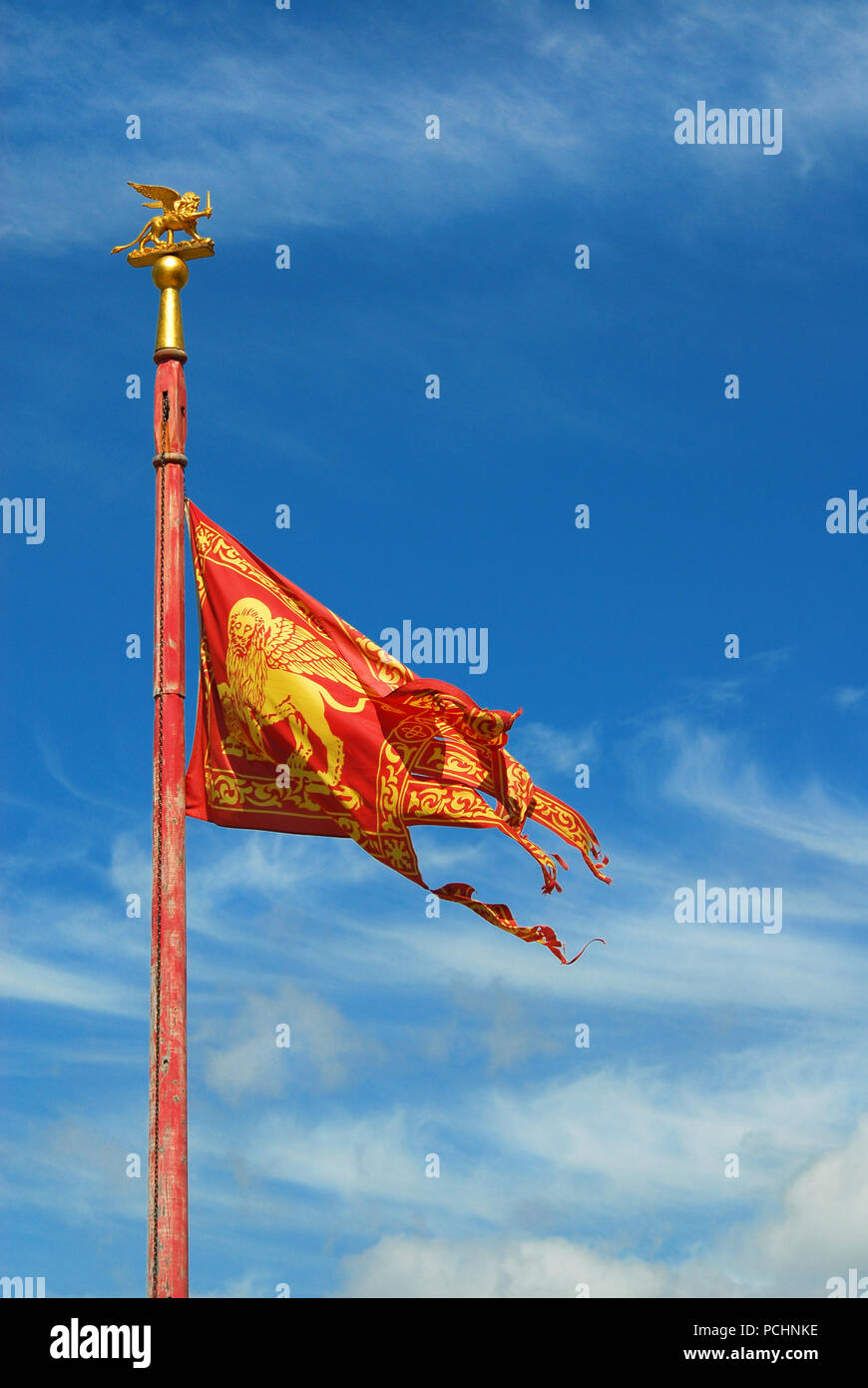 Old Venice Republic Flag with Saint Mark Lion fluttering in the wind (with copy space) Stock Photo