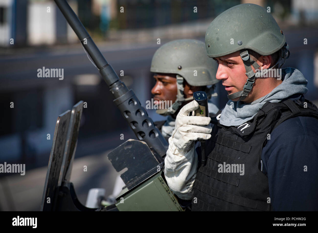 180731-N-UY653-059  ALGIERS, Algeria (July 31, 2018)  Fire Controlman 2nd Class Dalton Eiler, right, and Gunner’s Mate 2nd Class Jokenzie Broughton man a .50-caliber machine gun aboard the Arleigh Burke-class guided-missile destroyer USS Carney (DDG 64) as the ship departs Algiers, Algeria, following a scheduled port visit July 31, 2018. Carney, forward-deployed to Rota, Spain, is on its fifth patrol in the U.S. 6th Fleet area of operations in support of regional allies and partners as well as U.S. national security interests in Europe and Africa. (U.S. Navy photo by Mass Communication Special Stock Photo