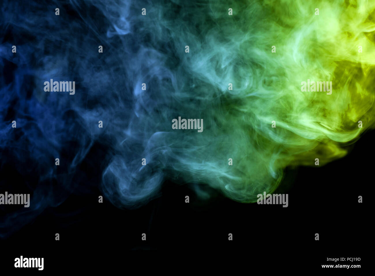 Green and blue cloud of smoke of black isolated background. Background