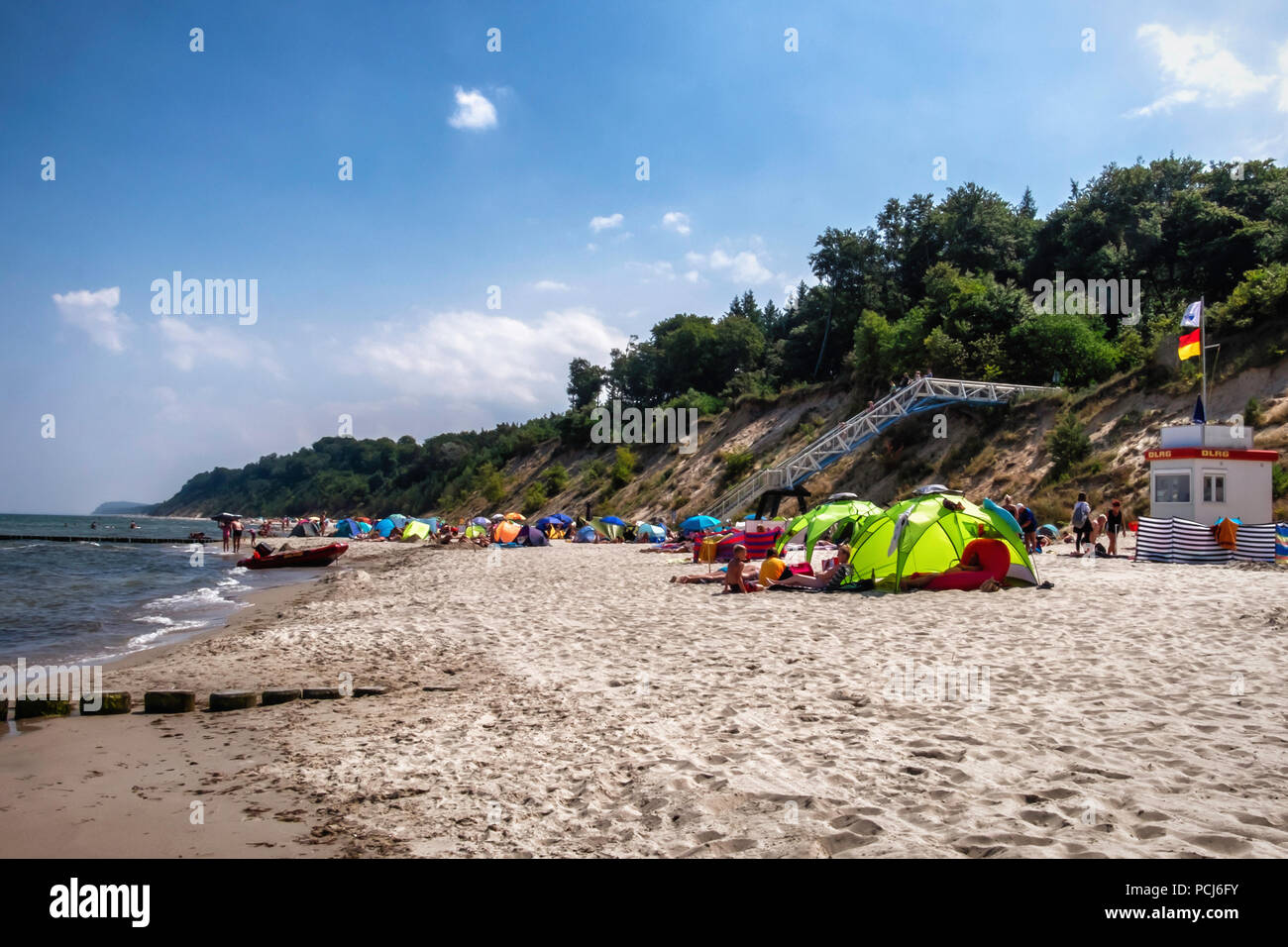 Germany Loddin,Stubbenfelde Beach. Coastal bathing resort on the island of Usedom on the Baltic Sea. People shade under colourful tents during Summer  Stock Photo