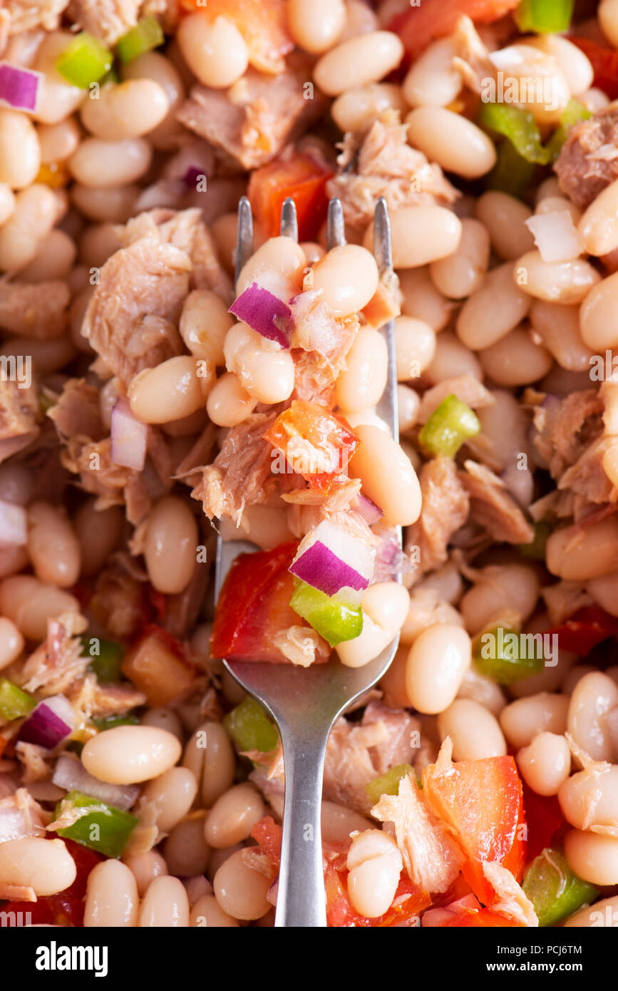 high angle view of a fork on a plate with a refreshing bean salad Stock Photo