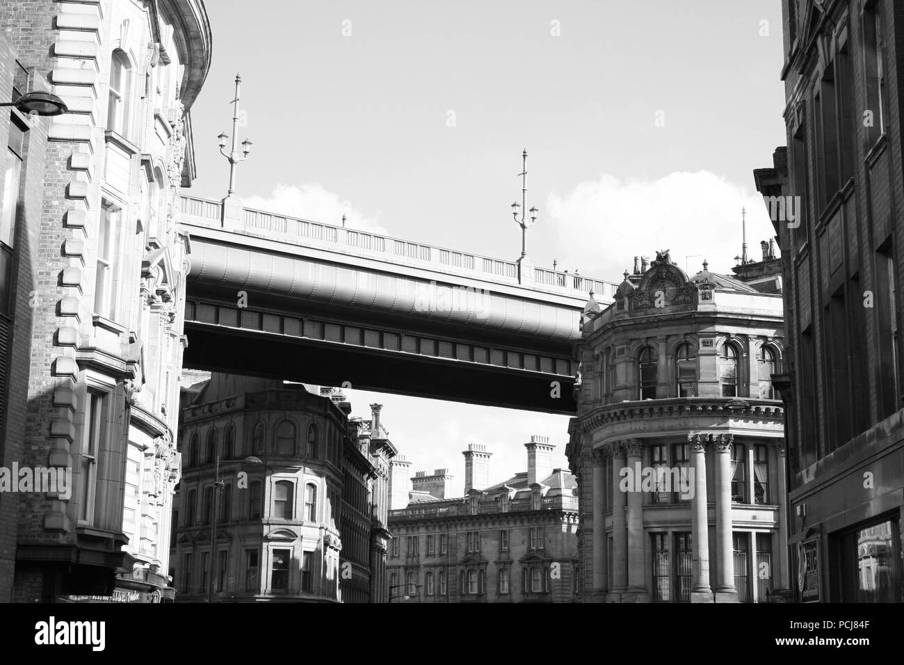 Newcastle's famous Tyne Bridge over Phoenix House on Dean Street Side on a sunny day. Black and White Stock Photo