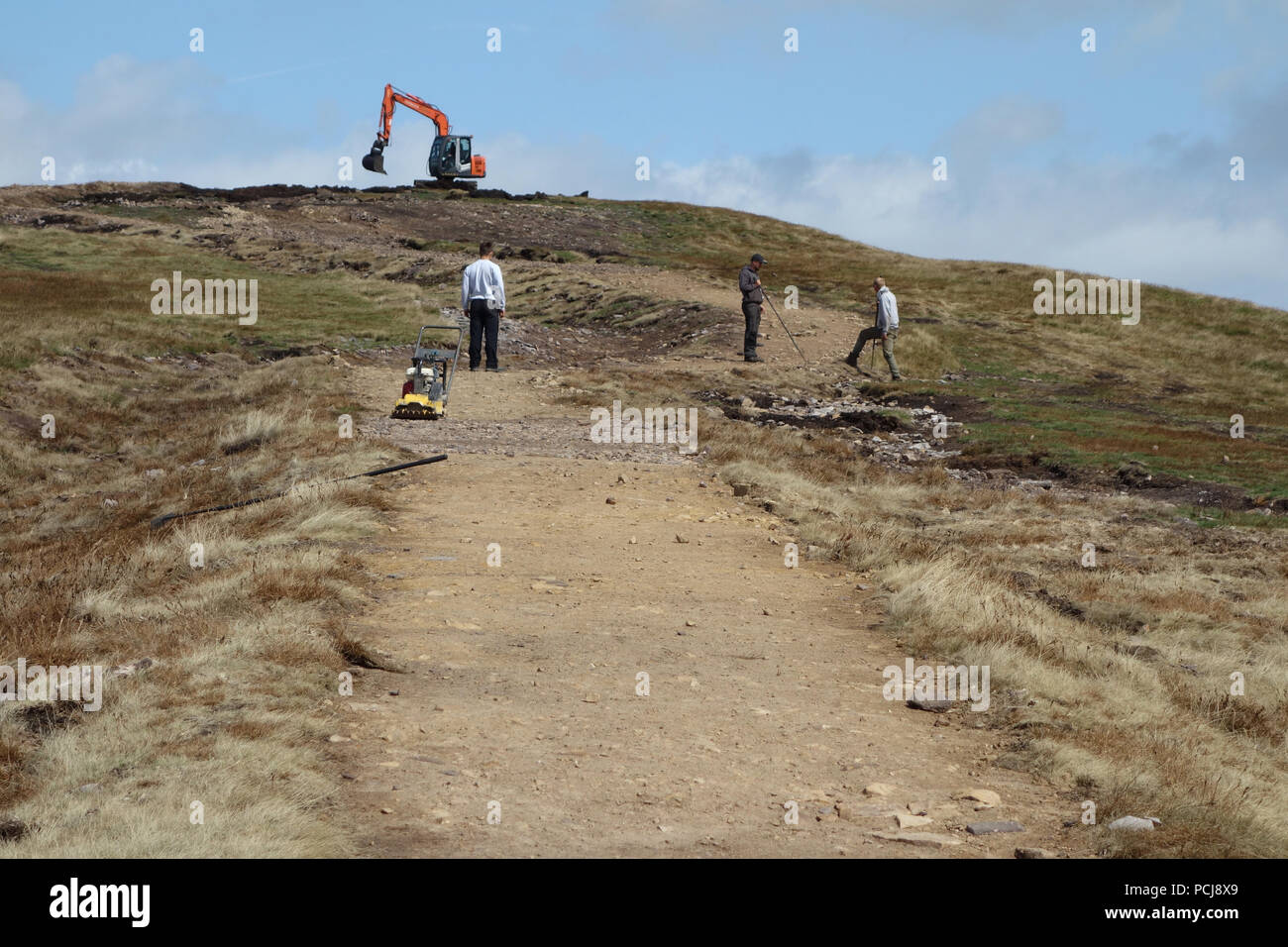 Workmen Working on the New Path Being Constructed Leading up to the Trig Column on the Summit of Pendle Hill, Lancashire, England, UK Stock Photo