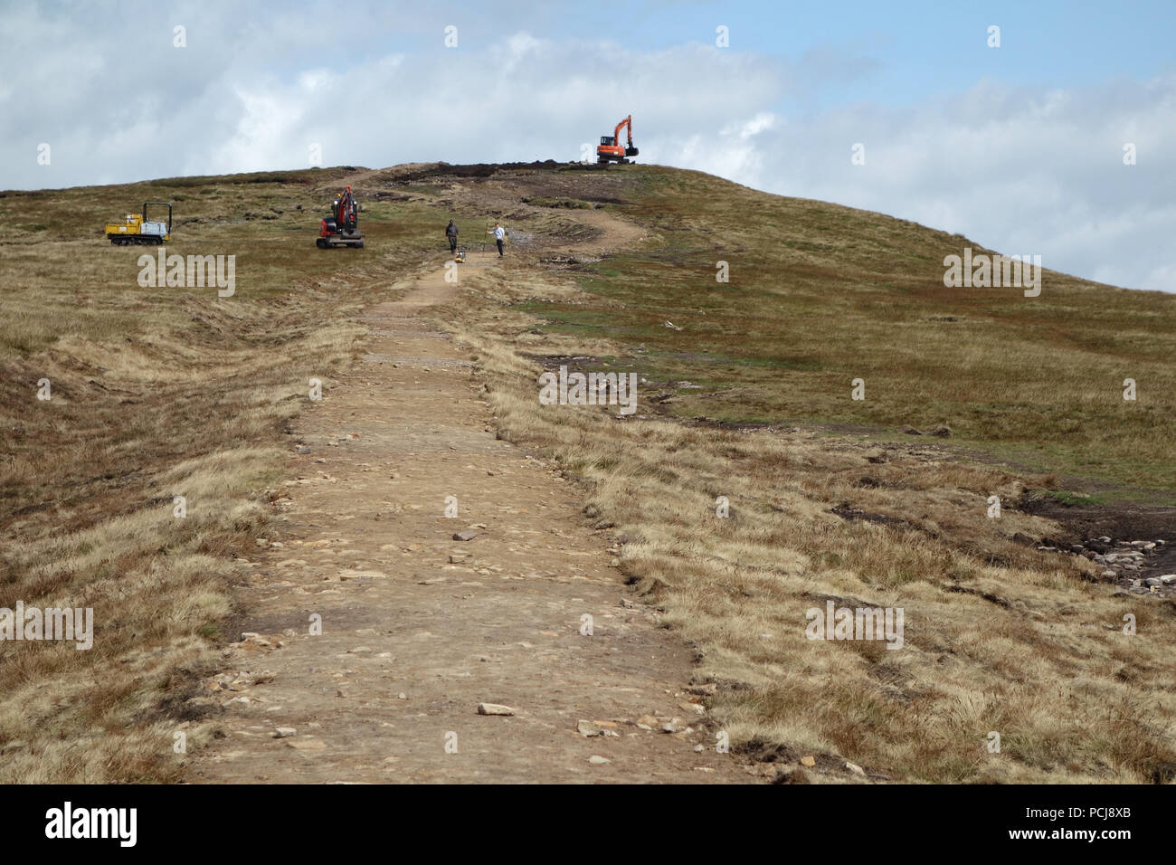 Workmen Working on the New Path Being Constructed Leading up to the Trig Column on the Summit of Pendle Hill, Lancashire, England, UK Stock Photo