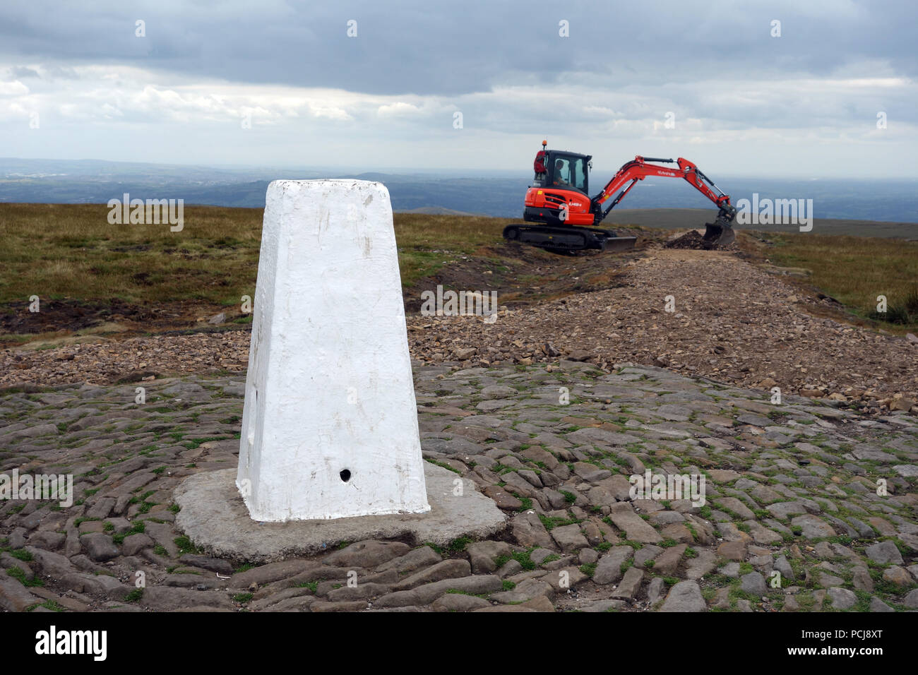 Mechanical Digger Working on the New Path Being Constructed Leading up to the Trig Column on the Summit of Pendle Hill, Lancashire, England, UK Stock Photo