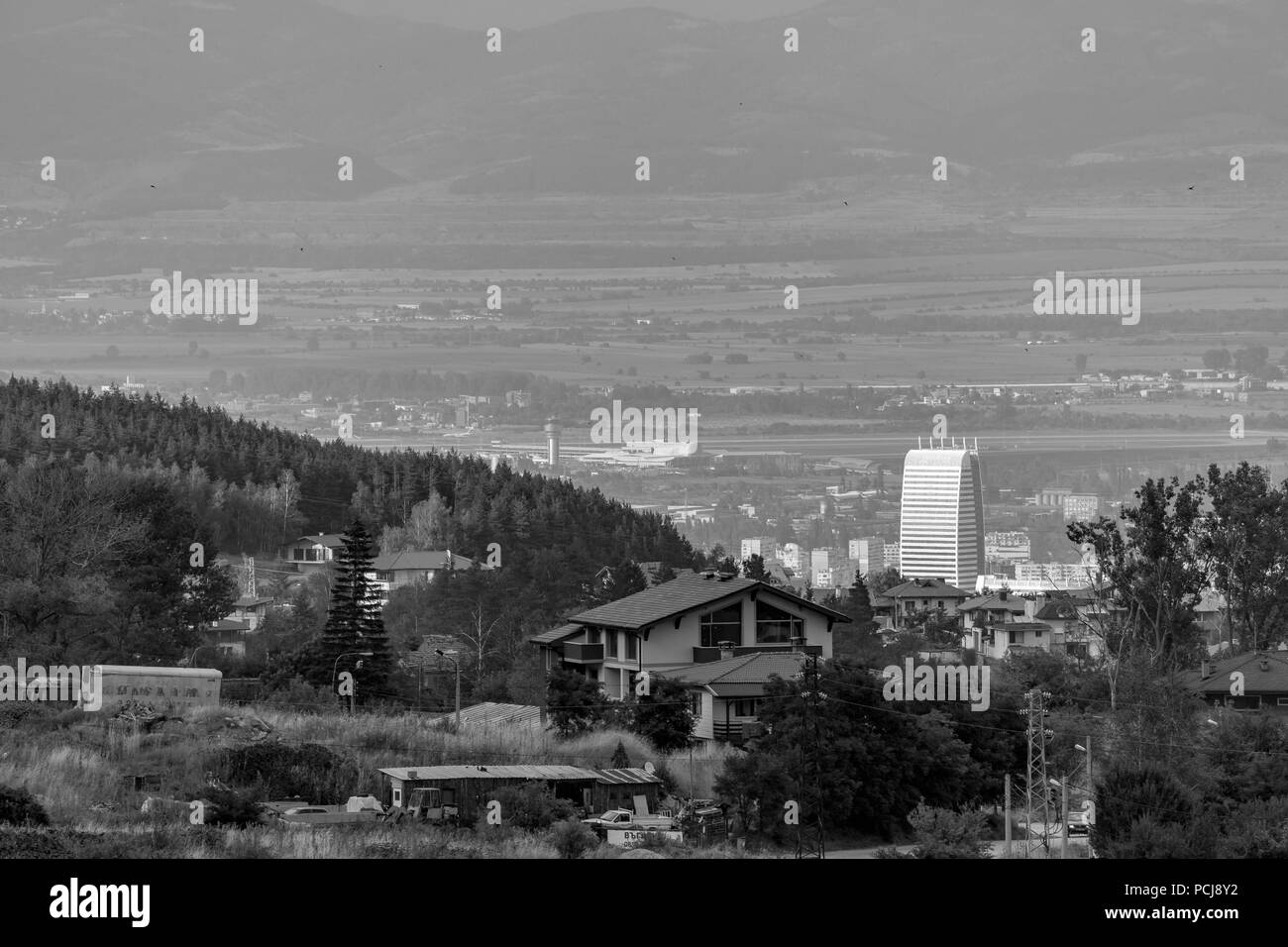 Black and white scenery landscape elevated view of Eastern Sofia and the airport in a summer day with haze in the air. Vitosha mountain, Bulgaria Stock Photo