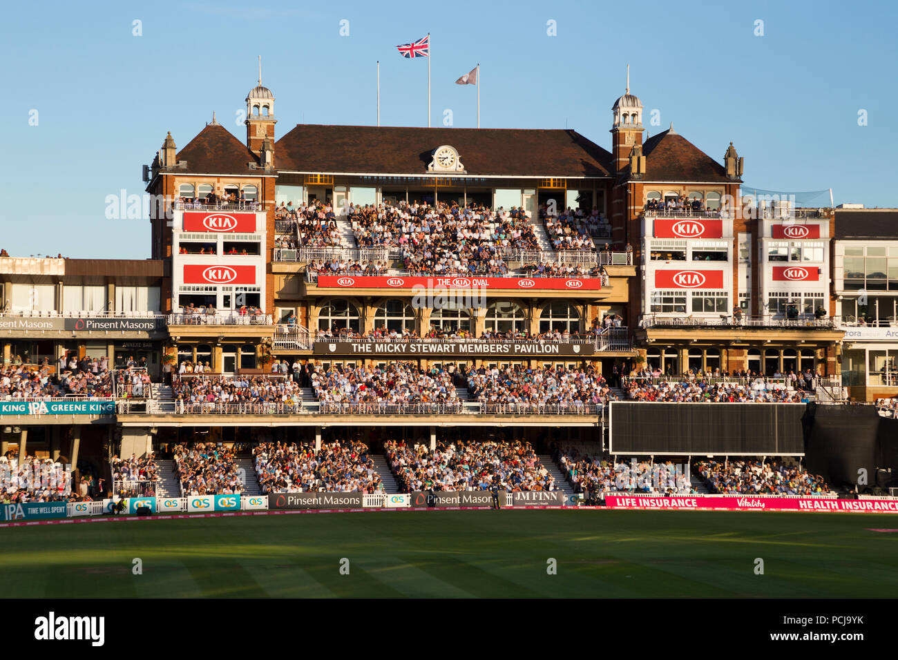 The Micky Stewart Members' Pavilion overlooking 20 20 day night match and the cricket pitch / wicket of The Oval cricket ground (The Kia Oval) Vauxhall, London. UK. (100) Stock Photo
