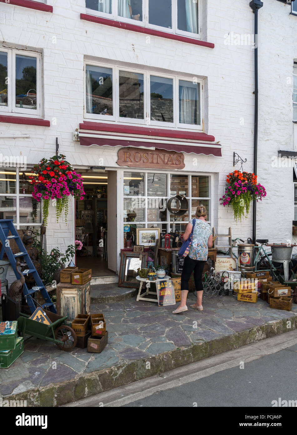 vintage looks furniture color woman looks at pavement display of goods outside rosinas gift and vintage furniture shop in polperro cornwall england uk vintage looks furniture color woman looks at pavement display of goods outside rosinas gift and vintage furniture shop in polperro cornwall england uk