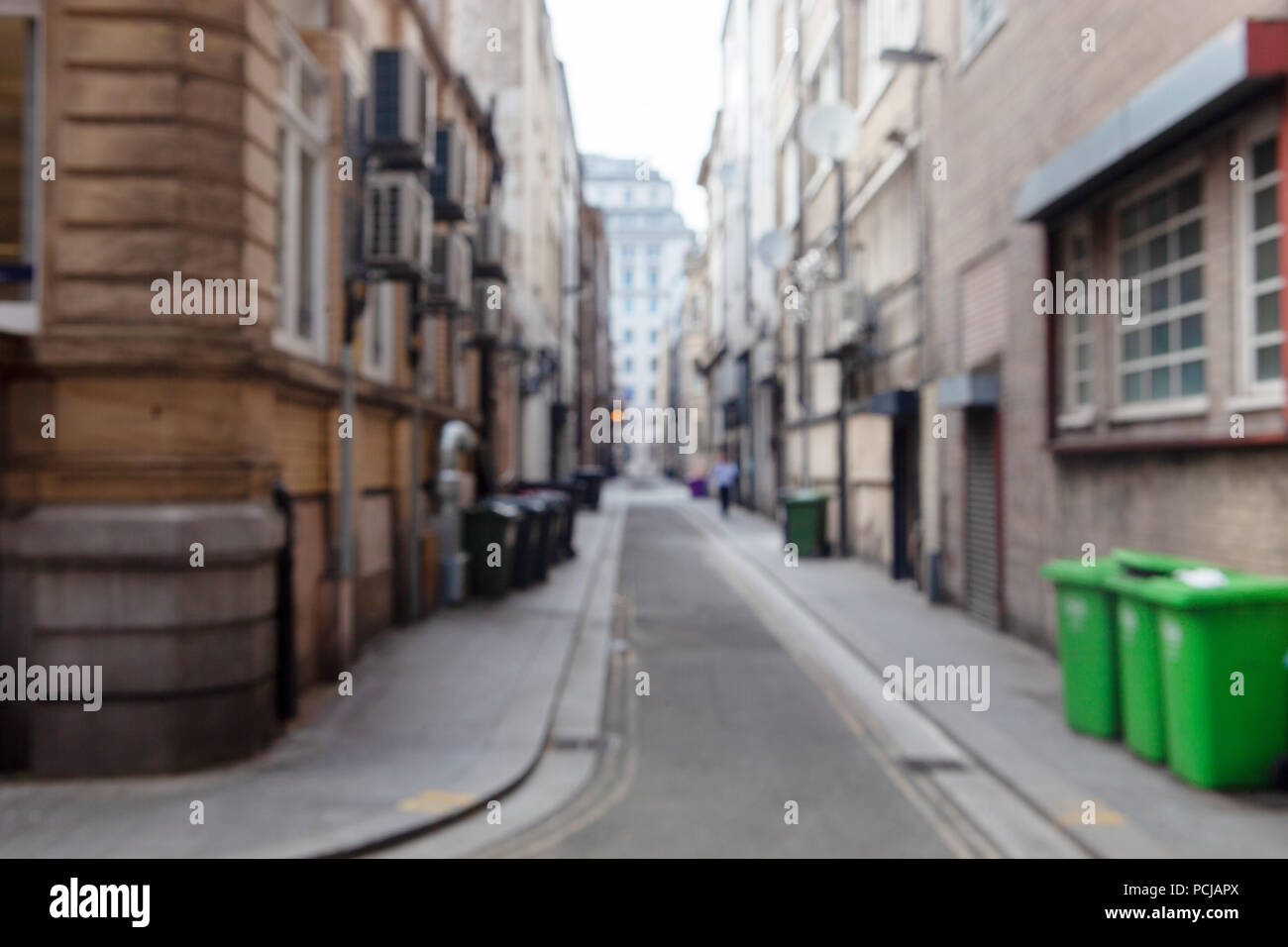 Blurred view of London dirty back street with shops, trash cans and buildings. Can be used as background Stock Photo