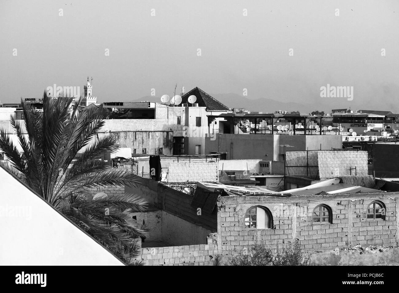 Marrakech Medina, roofs of old city, panorama, buildings, palm, mosque tower, view of the terraces. Black and white. Monochrome. Arabic city. Morocco. Stock Photo