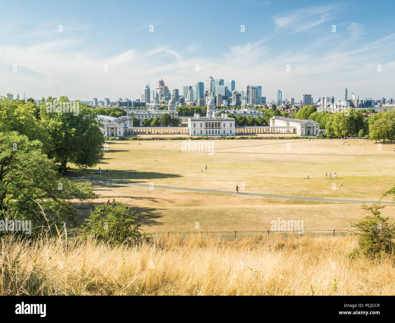View from Greenwich Park towards the University (Old Royal Naval College) with the Skyscrapers of Canary Wharf  behind. Stock Photo