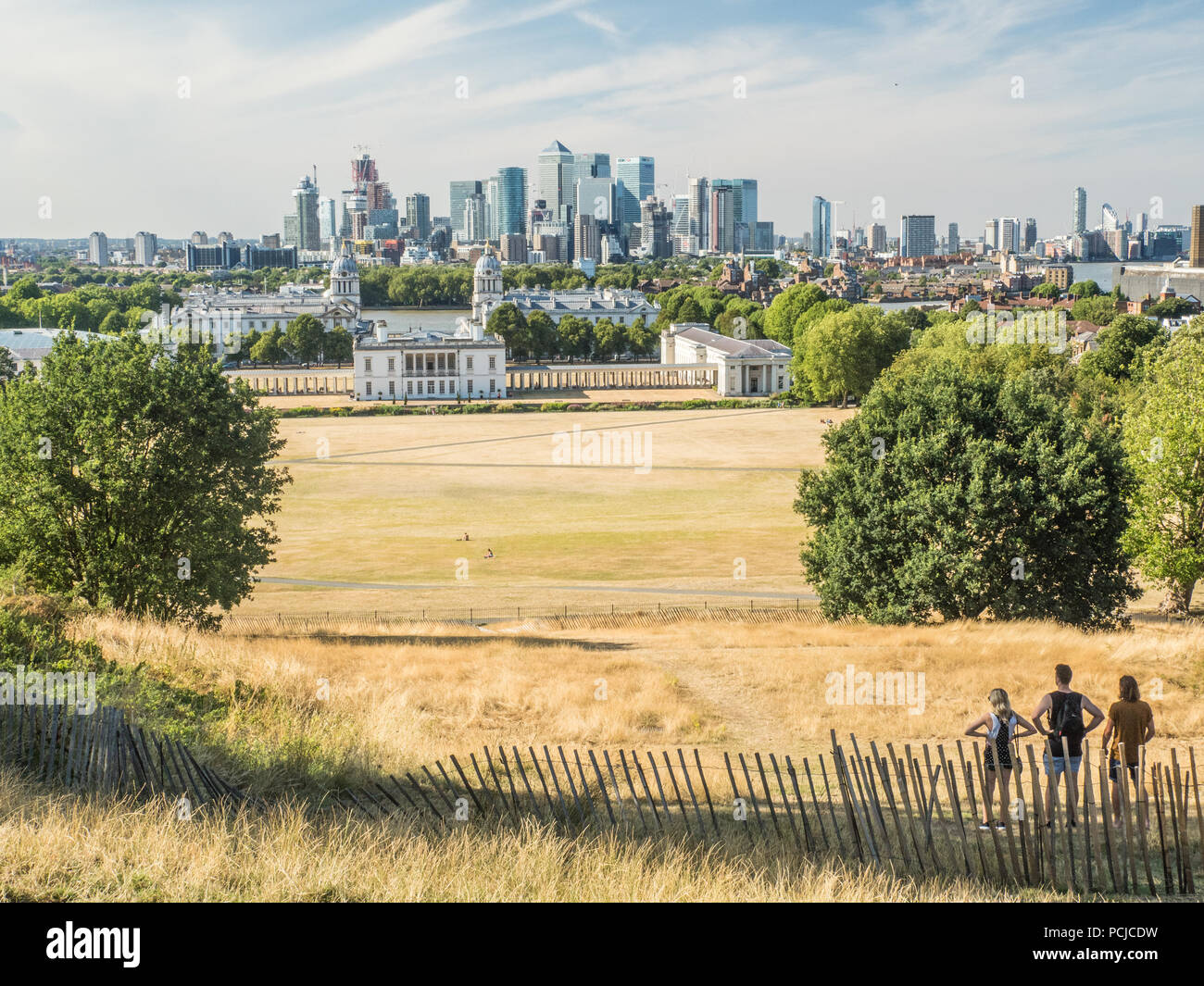 View from Greenwich Park towards the University (Old Royal Naval College) with the River Thames and the Skyscrapers of Canary Wharf  behind. Stock Photo