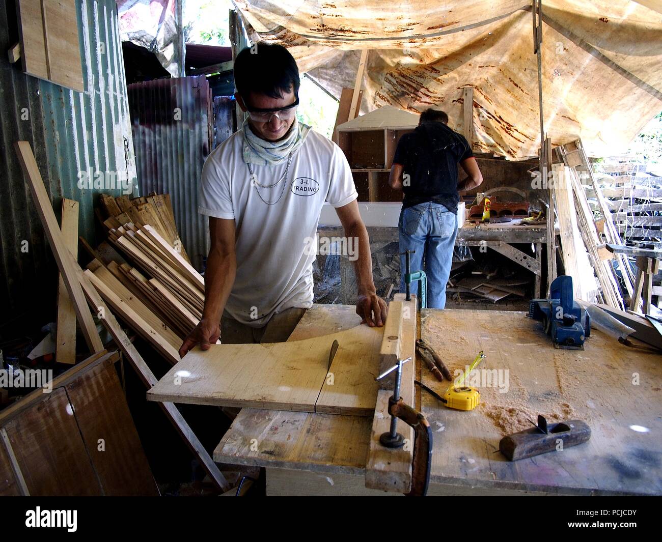ANTIPOLO CITY, PHILIPPINES JULY 31, 2018 A carpenter cuts wood using