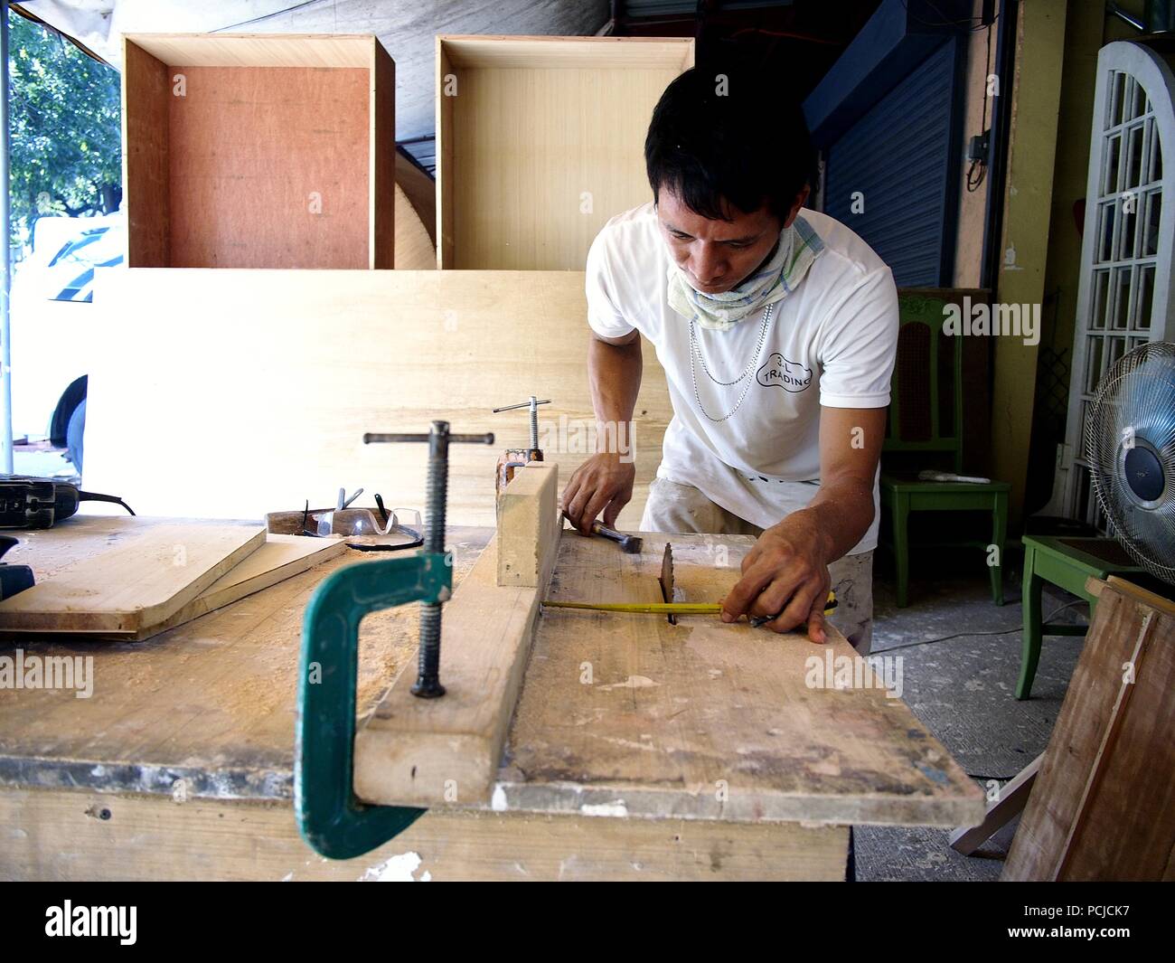 ANTIPOLO CITY, PHILIPPINES JULY 31, 2018 A carpenter cuts wood using