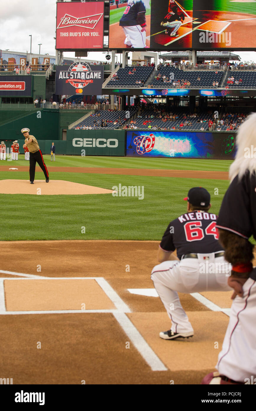 Major Gen. John R. Ewers Jr., staff judge advocate to the Commandant of the Marine Corps, throws the first ceremonial pitch during U.S. Marine Corps Day at Nationals Park, Washington D.C., July 31, 2018. The Washington Nationals hosted Marines stationed around the National Capital Region to participate in pre-game events to honor the Marine Corps. (Official U.S. Marine Corps photo by Sgt. Robert Knapp/Released) Stock Photo