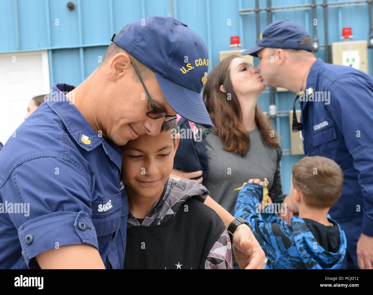 Petty Officer 1st Class Alberto Sanchez, a machinery technician aboard the Coast Guard Cutter Alex Haley (WMEC 39), hugs his son after the cutter moored at its homeport in Kodiak, Alaska, August 1, 2018. The crew members aboard the Alex Haley returned home from a 90-day deployment patrolling more than 16,000 miles throughout the Pacific Ocean. U.S. Coast Guard photo by Petty Officer 3rd Class Lauren Dean. Stock Photo