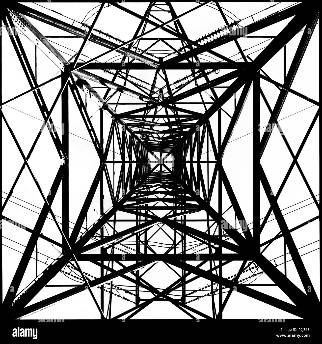 Symmetrical black and white view from underneath a pylon showing multiple squares and rectangles in a tessellating pattern Stock Photo