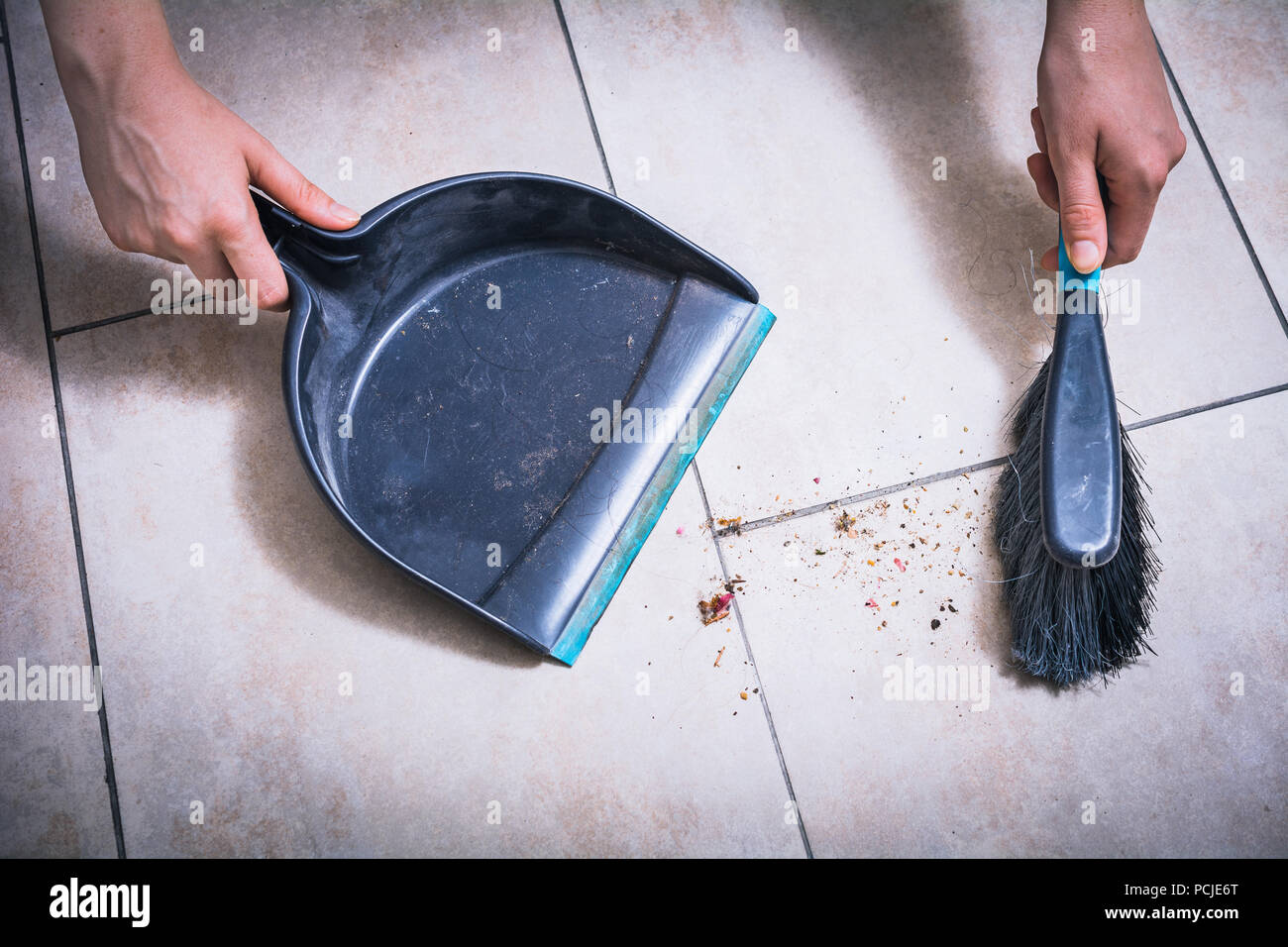 Cleaning Dust On Tile Floor With Brush And Dustpan Holded By Female