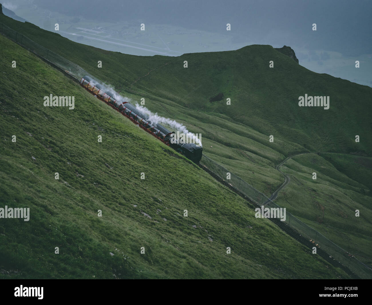 old steam train on a mountain track in the swiss alps, brienzer rothorn bahn in switzerland Stock Photo