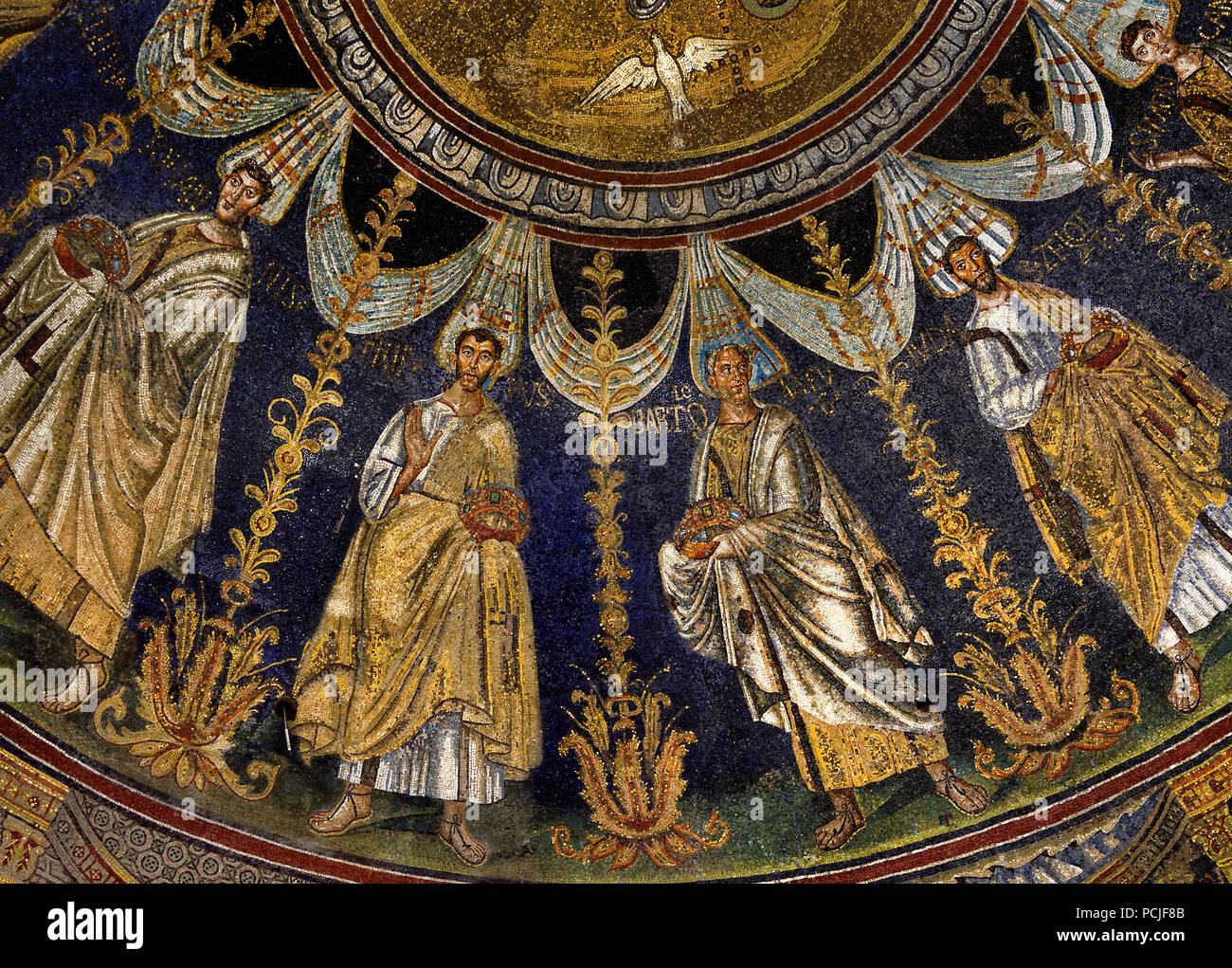 Neonian Baptistery in Ravenna - Mosaics ( late Roman and Byzantine architecture,) Emilia-Romagna - Northern Italy. ( UNESCO World Heritage site ) St John the Baptist baptizing Jesus.. in the Jordan River. A procession of the twelve apostles proceeds around the centre mosaic in two directions, ending with St Peter meeting St Paul. Stock Photo