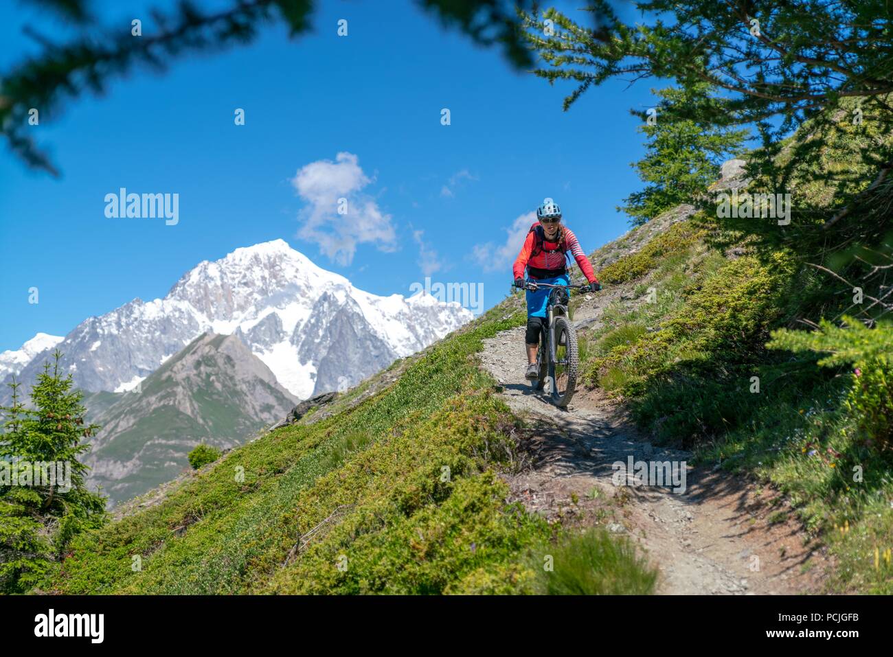 Woman Mountain Biking near Mont Blanc, Aosta Valley, Italy Stock Photo