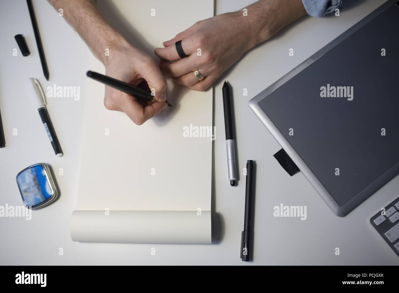 Designer hands drawing design project.  Stock Photo