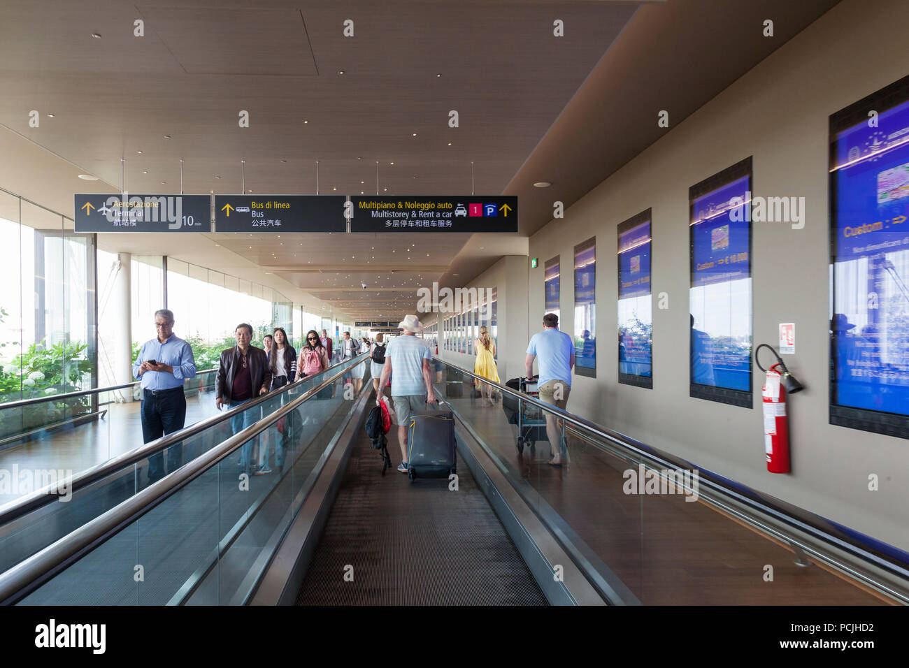 Passengers at Venice Marco Polo International airport, Venice, Veneto, Italy  using the conveyor belt to transfer from the ferry docks to the terminal  Stock Photo - Alamy