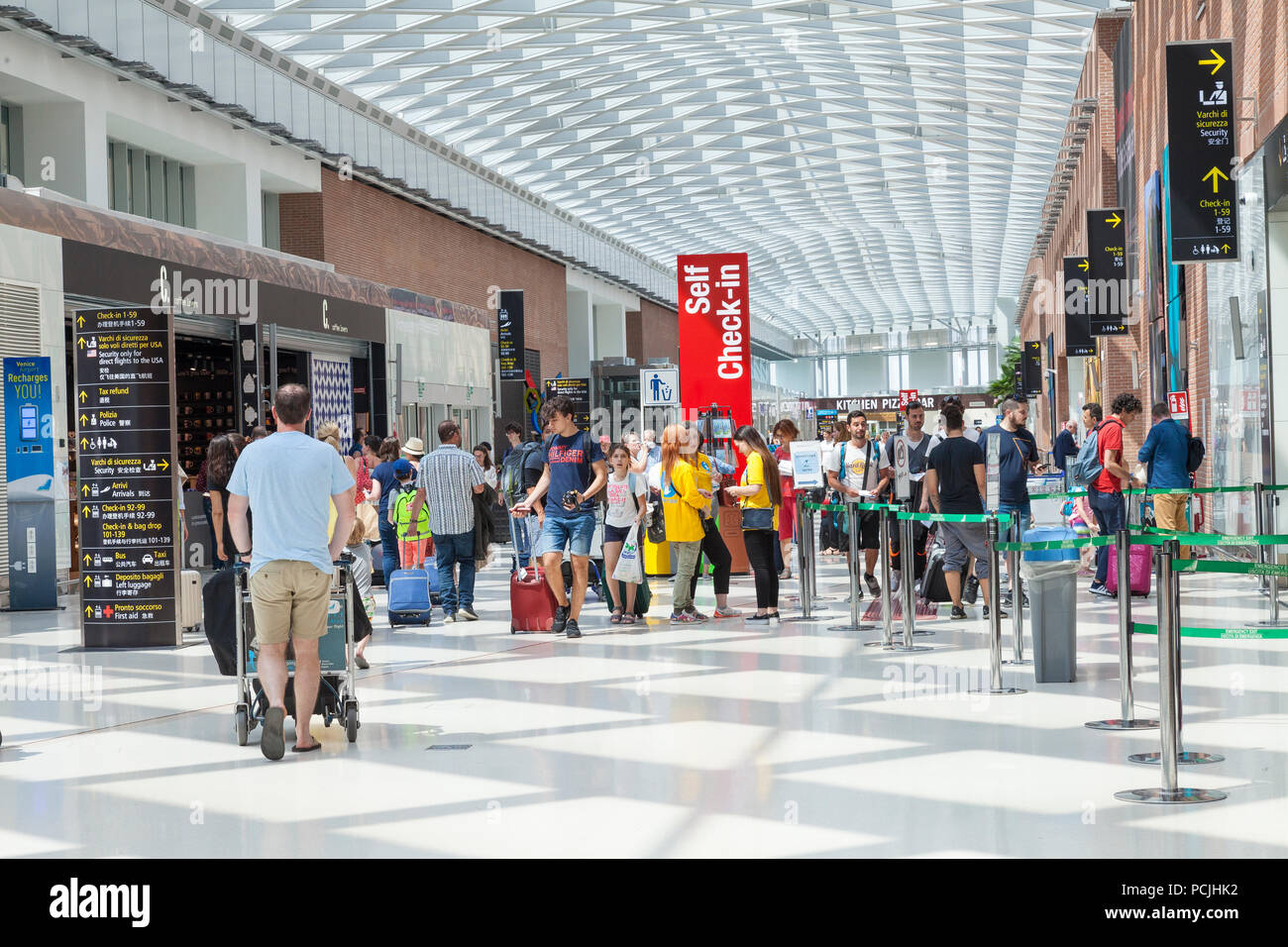 Passengers at Venice Marco Polo International airport, Venice, Veneto,  Italy inside the arrivals terminal with families and kids Stock Photo -  Alamy