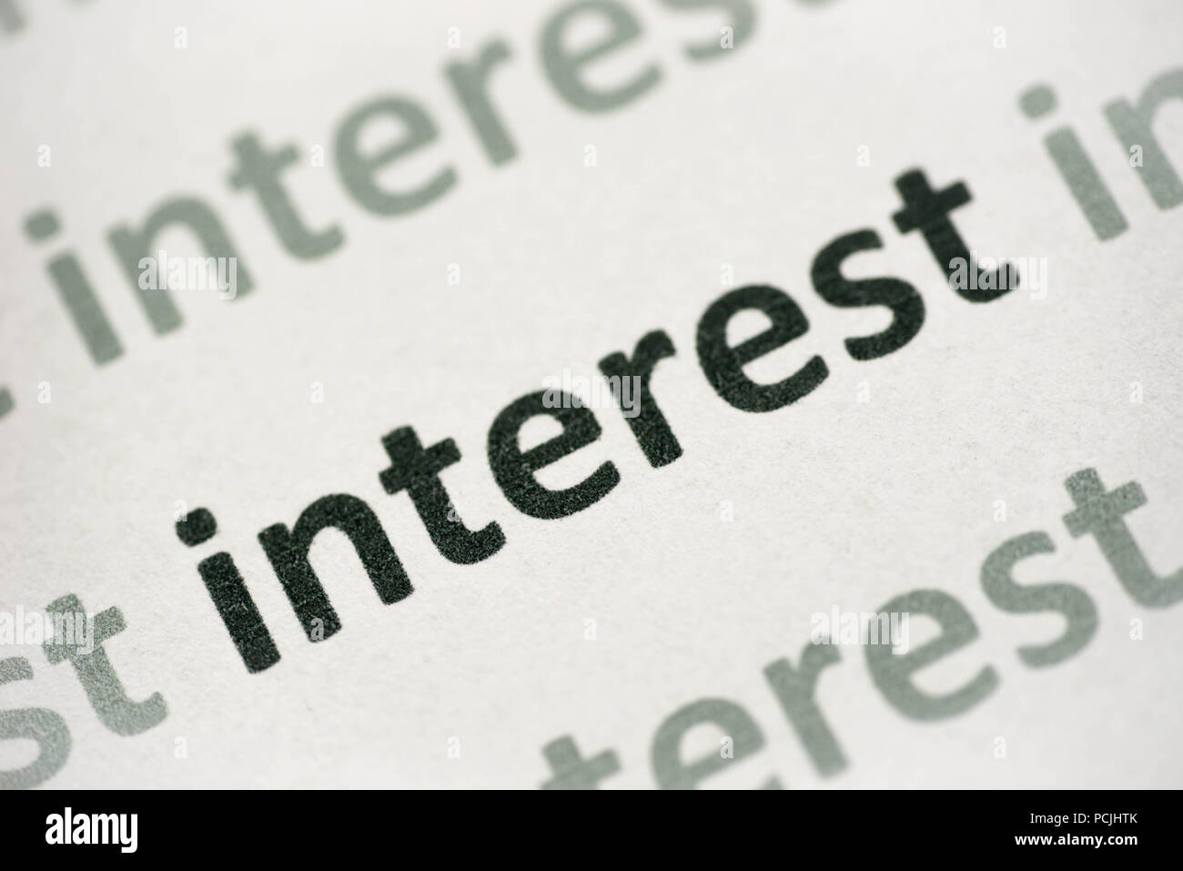 word interest printed on white paper macro Stock Photo