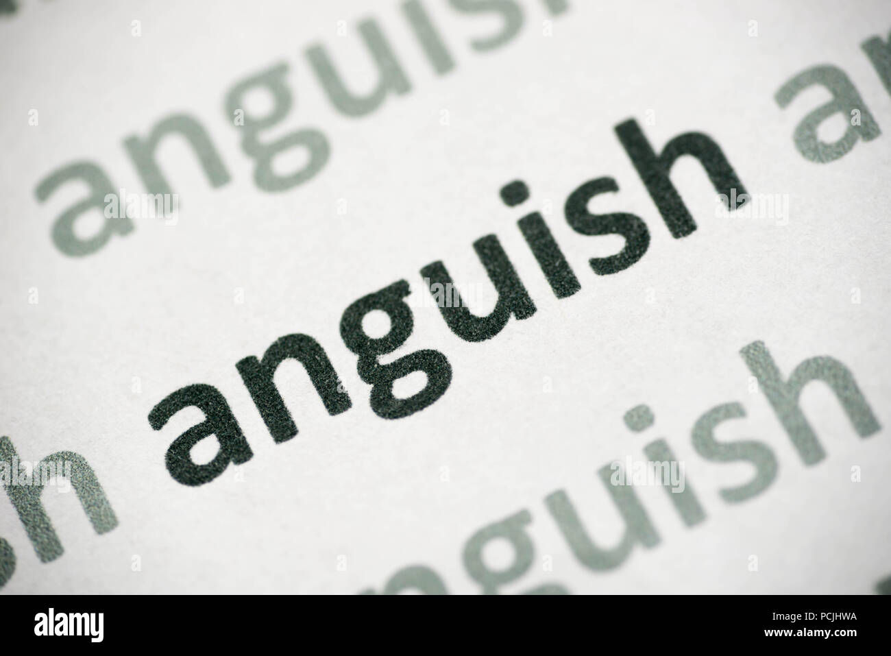 word anguish printed on white paper macro Stock Photo Alamy