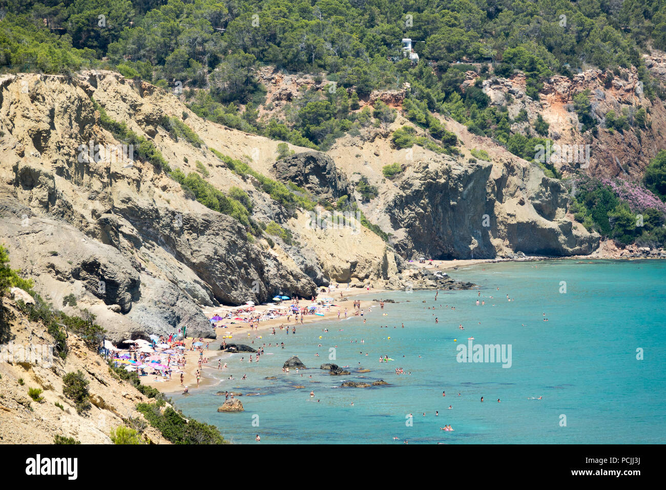 Visitors and holidaymakers on Agua Blanca beach  in Ibiza, Spain. Stock Photo