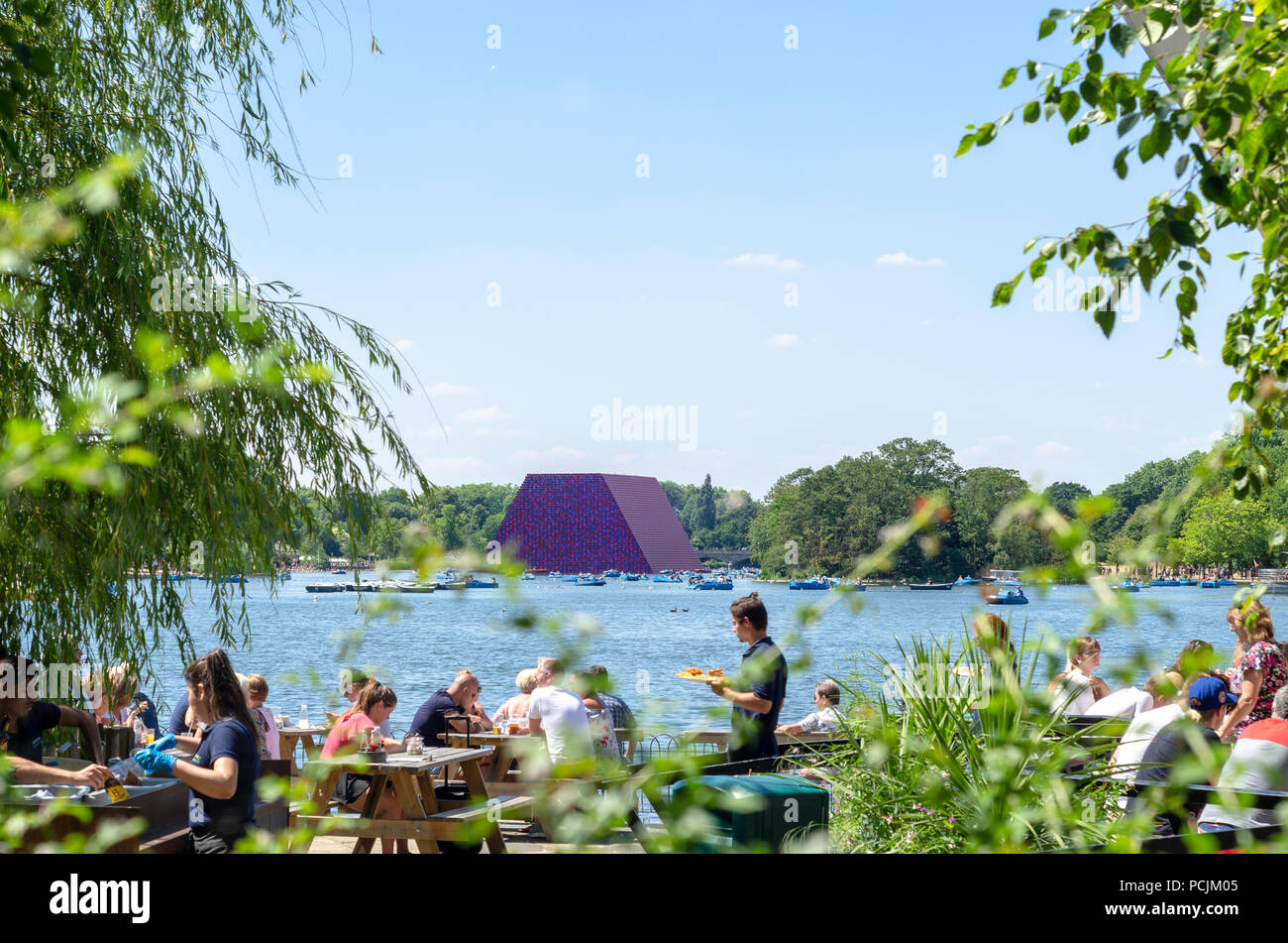 Tourists at the Serpentine at Hyde Park Christo's Mastaa floating in the background. Stock Photo