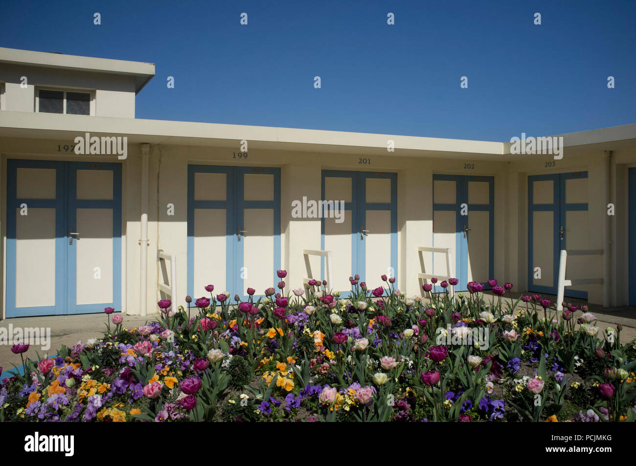 Colourful blue and white painted period changing rooms under a clear blue sky by the beach at Trouville-sur-Mer, France Stock Photo