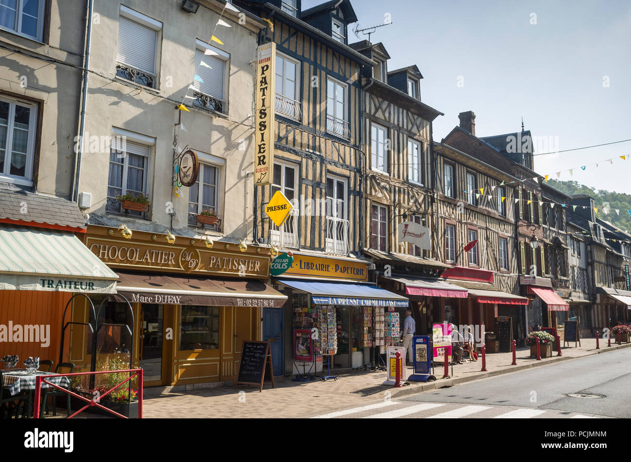 Street scene with ancient half-timbered shops the high street in Cormeilles, Normandy, France on a sunny day with clear blue sky Stock Photo
