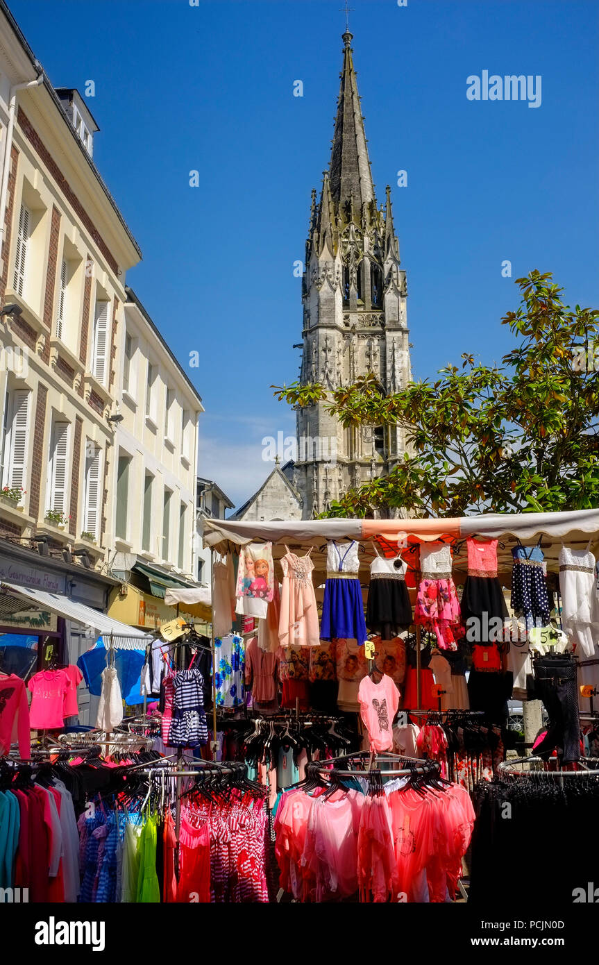 Market day in Lillebonne, Normandy, France with the church behind and colourful market stalls Stock Photo