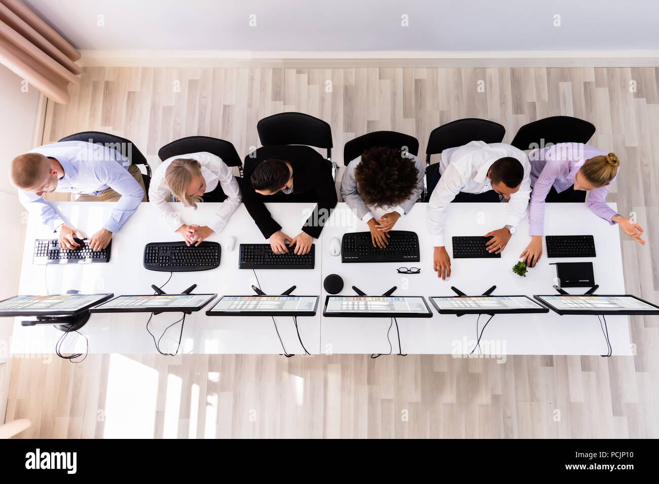 Skilled Young Business Executives Working On Computer In Office Stock Photo