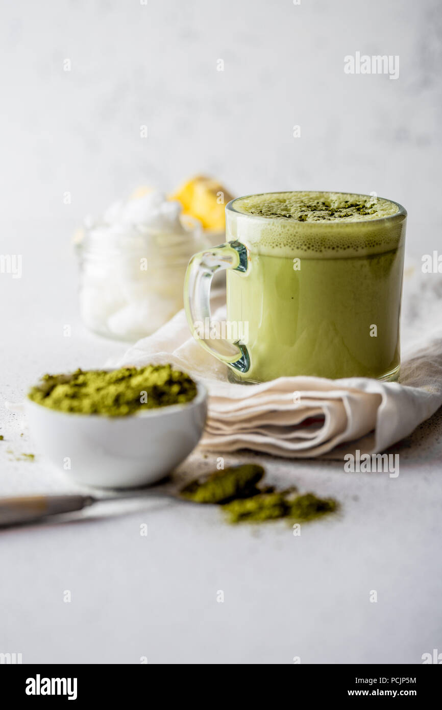 BULLETPROOF MATCHA. Ketogenic keto diet hot drink. Tea matcha blended with coconut oil and butter. Cup of bulletproof matcha and ingredients on white background Stock Photo