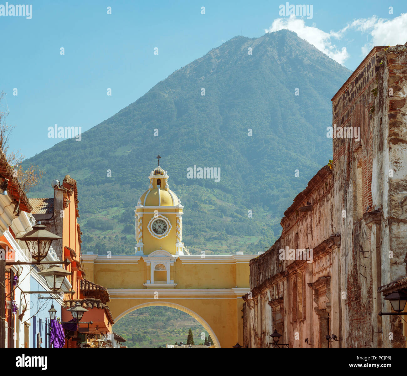 Volcan de Agua looms high behind the city of Antigua, Guatemala in Central America Stock Photo