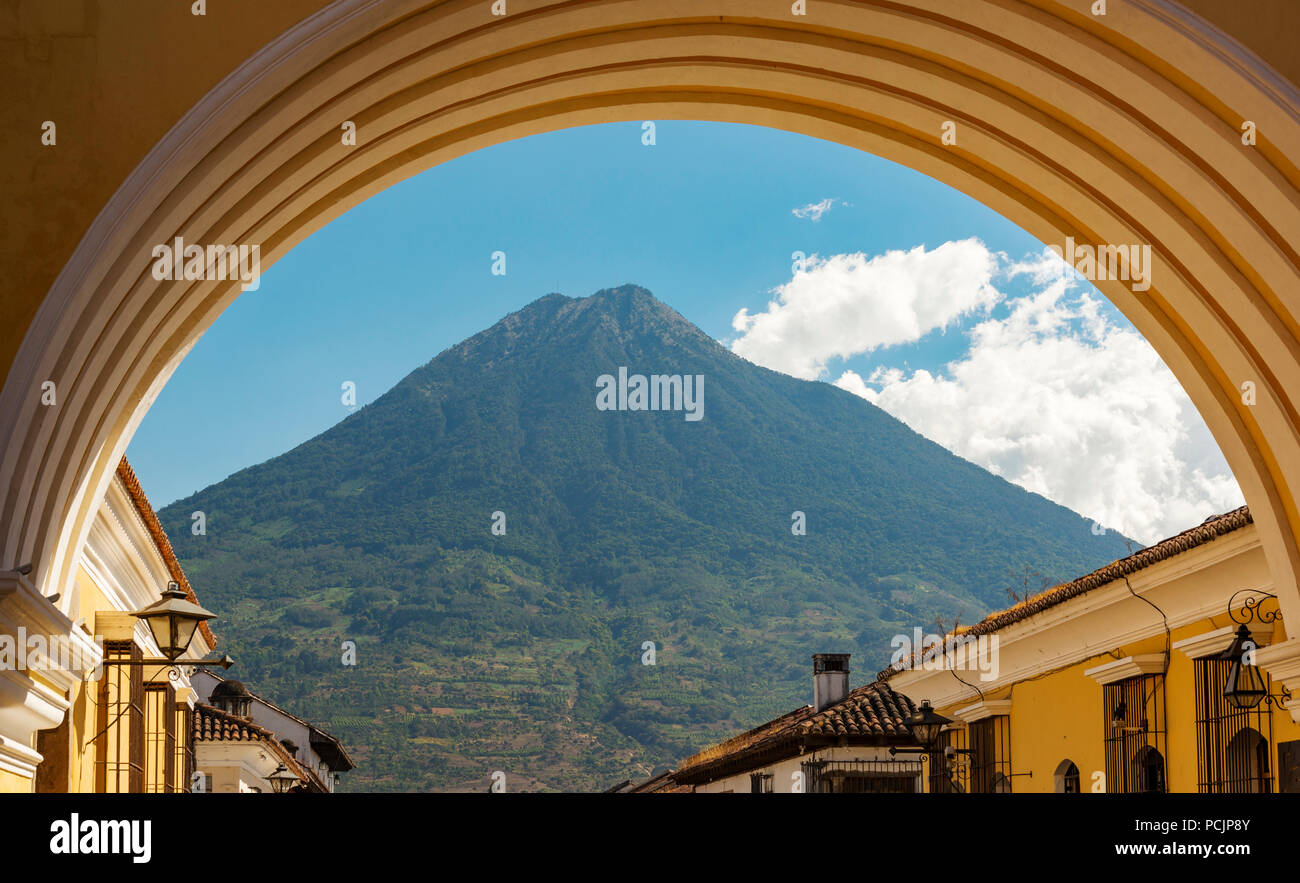 Volcan de Agua looms high behind the city of Antigua, Guatemala in Central America Stock Photo