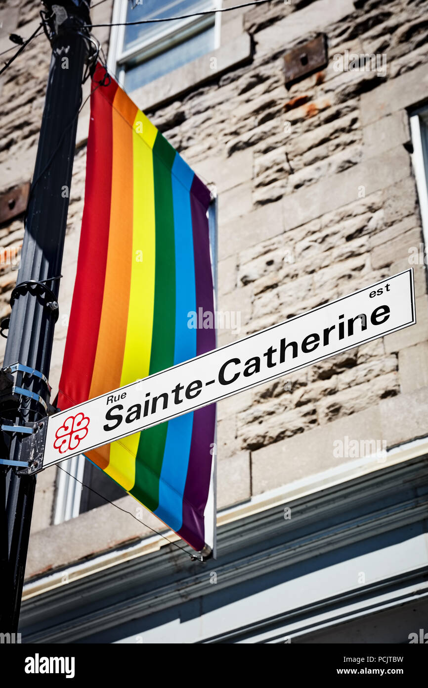 Sainte Catherine street sign and a rainbow flag in gay village of ...