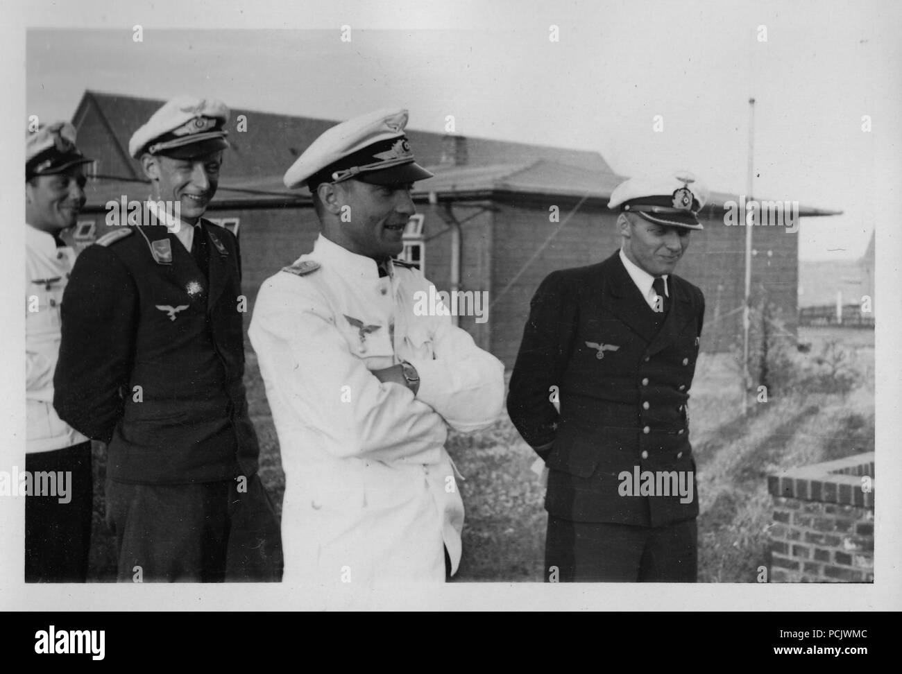 Image from the photo album of Oberleutnant Wilhelm Gaul: Willi Gaul (on right) in Kriegsmarine uniform stands with Luftwaffe officers in summer uniform. Will Gaul served with 1. Staffel, Küstenfliegergruppe 106 as a naval aircrew observer in 1939-1940 until he transferred to the Luftwaffe. Stock Photo