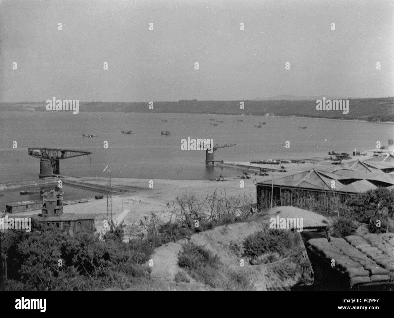 Image from the photo album of Oberleutnant Wilhelm Gaul - An array of Luftwaffe floatplanes, including Heinkel He 115s and Dornier Do 24s, fill the harbour at Brest in 1941 or 1942. Stock Photo