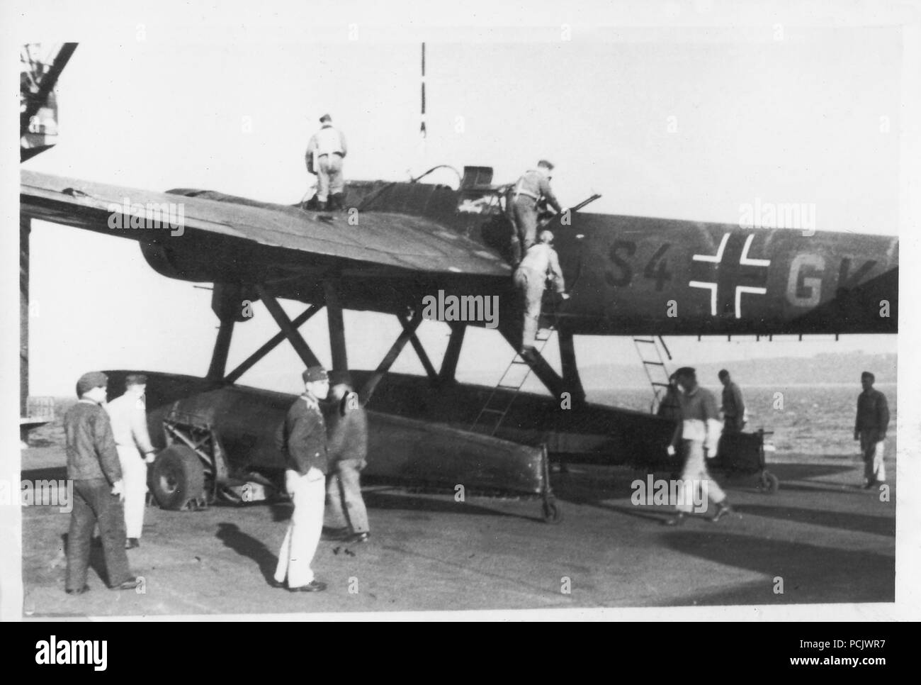 Image from the photo album of Oberleutnant Wilhelm Gaul - Still bearing the codes of its former unit, 2. Staffel, Küstenfliegergruppe 506, a Heinkel He 115 of 2. Staffel Küstenfliegergruppe 906 prepares to lift as the crew board in October 1941. Stock Photo