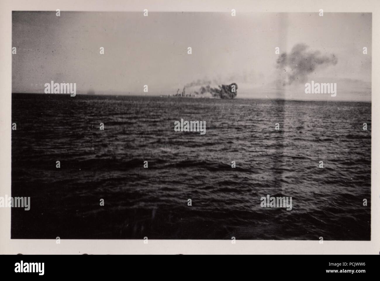 Image from the photo album of Oberfänrich Wilhelm Gaul - The German Heavy Cruiser Deutschland under air attack by Spanish Republican aircraft on 29 May 1937. Their bombs caused large fires on Deutschland, killed 31 sailors and wounded 74. Stock Photo