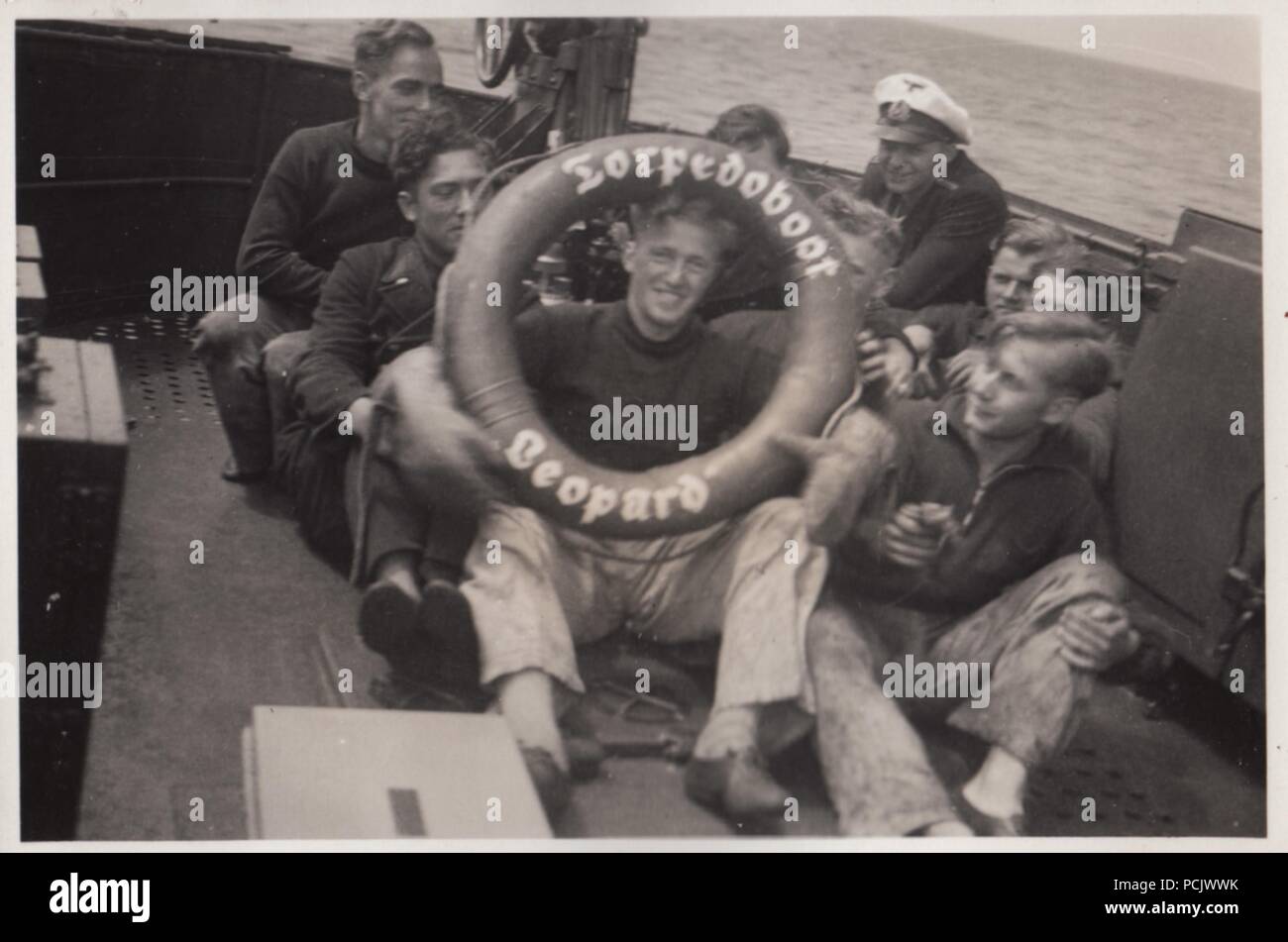 Image from the photo album of Oberfänrich Wilhelm Gaul - Members of the crew on board German Torpedo Boat Leopard pose with a life ring during the Spanish Civil War. Stock Photo
