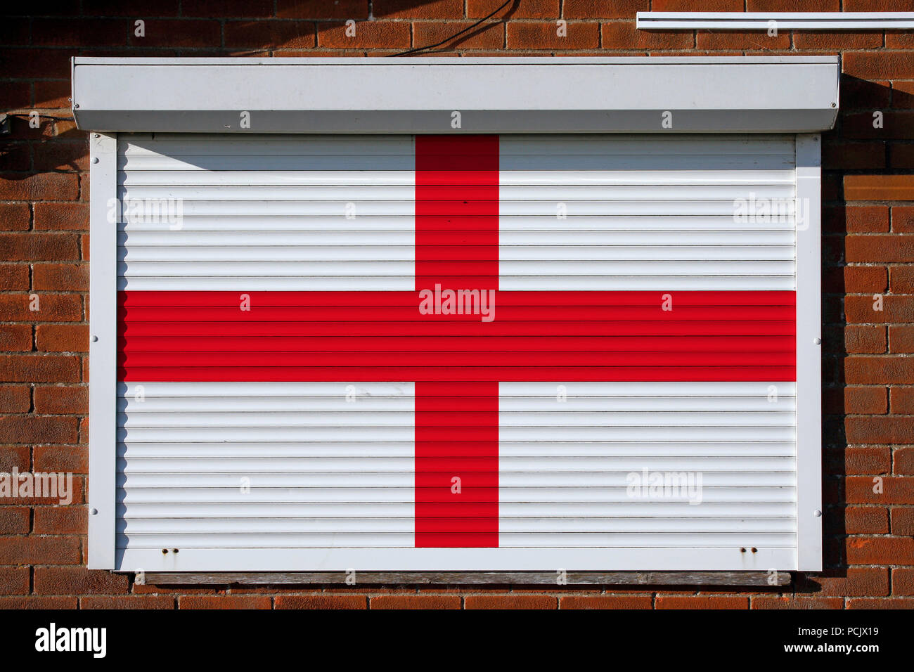 English flag on closed steel security shutters Stock Photo